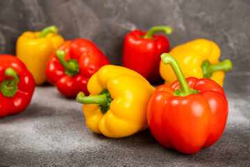 Fresh colorful red and yellow bell peppers on marble background. Bell pepper. Vegetables. Vegan food. Healthy foods. Place for text. Place to copy. Diet concept.