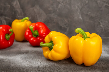 Fresh colorful red and yellow bell peppers on marble background. Bell pepper. Vegetables. Vegan food. Healthy foods. Place for text. Place to copy. Diet concept.