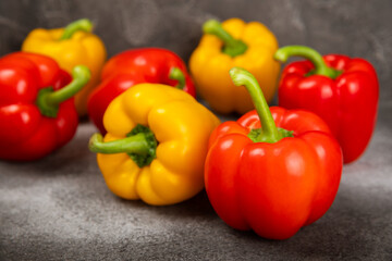 Fresh colorful red and yellow bell peppers on marble background. Bell pepper. Vegetables. Vegan food. Healthy foods. Place for text. Place to copy. Diet concept.