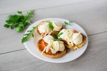 fried in batter sandwiches with tomatoes and mozzarella in a plate with herbs