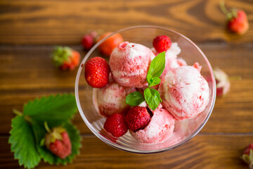 Balls of homemade strawberry ice cream in a bowl