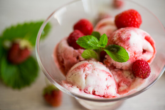 Balls of homemade strawberry ice cream in a bowl