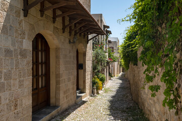 Fototapeta na wymiar Picturesque and Charming Alley Way of Rhodes Medieval Old Town Greece