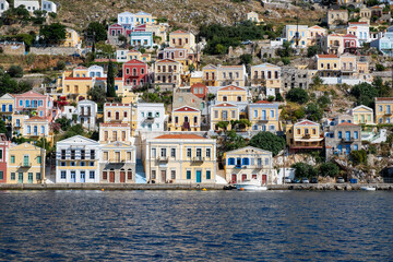 Fototapeta na wymiar A Closeup View of Houses on the Port of Symi in the Late Afternoon