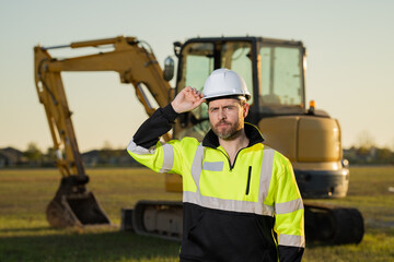 Builder in helmet on the construction site.