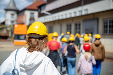 Back view woman tourist wear yellow safety helmet equipment at Rammelsberg Unesco Mine trip...