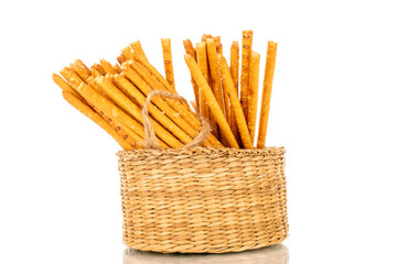 Straw is a bakery product. Several straws in a straw basket isolated on a white background