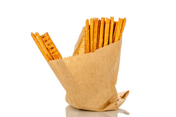 Straw is a bakery product. Several straws in a paper bag isolated on a white background