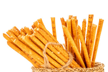 Straw is a bakery product. Several straws in a straw basket isolated on a white background