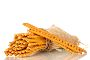 Straw is a bakery product. Several straws with a jute bag isolated on a white background