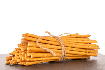 Straw is a bakery product. Several straws tied with jute string on slate stone isolated on white background
