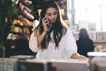 Young female talking on smartphone phoning