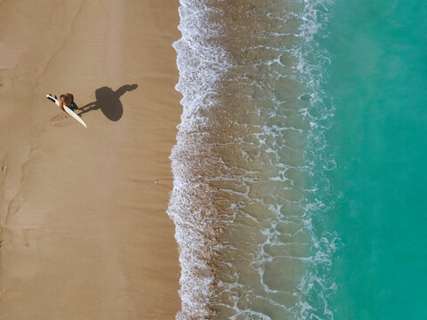 Aerial view of surfer at the beach - Powered by Adobe