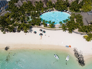 Fototapeta na wymiar Aerial view: Beautiful beach, palm trees and pool in Mauritius island