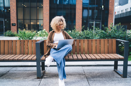 Young African American female freelancer working on laptop in street