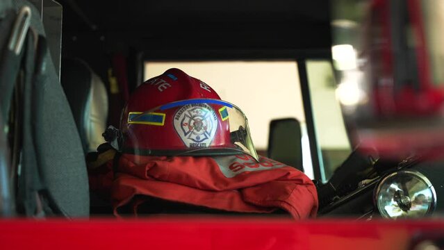 Close-up of red firefighter helmet lies on the seat in the cabin of a fire truck. Bomberos of Dominican Republic