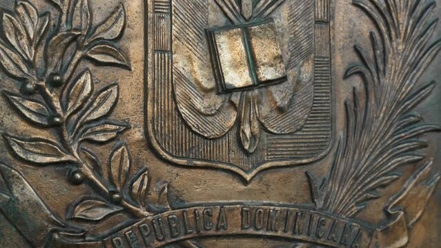 Close-up of copper Coat of arms of the Dominican Republic on La Puerta del Conde in Independence Park. Colonial city.