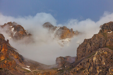 Passing clouds over a landscape in Turkey with snow capped mountains in the background. Landscape of mountain range and mountains.  Dedegol. Turkey.