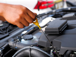 car mechanic checking car engine oil level and car engine oil quality