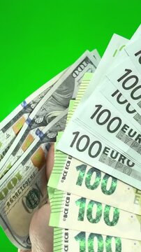 Several bills on one hundred holding dollars Top view of businesswoman's hands counting one hundred dollar banknotes on colorful background. Success and wealth concept Dollars to change to euros