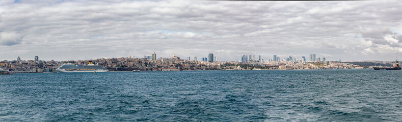 Fototapeta premium Istanbul detailed panorama as seen from Bosphorus. Beyoglu and Cihangir at skyline. Cruise liner at port. Banner. Istanbul, Turkey