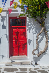 Greek island colorful plaza street house door of an old white architecture building in Mykonos,...