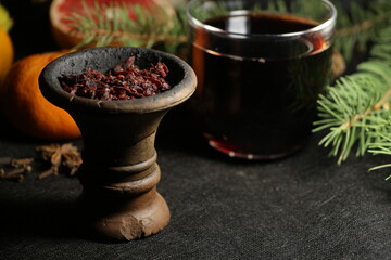 bowl with tobacco for hookah. nargile smoking. berries and fruits on a black background.