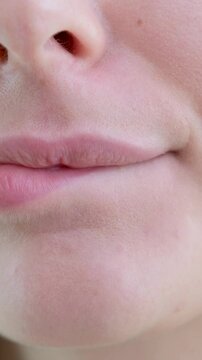 tender young girl woman close-up mouth lips bow worries bites lip licks fell in love have Fan pale pink part of body lip 