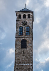 Fototapeta na wymiar Clock Tower next to Gazi Husrev-beg Mosque in Bascarsija, historic part of Sarajevo city, Bosnia and Herzegovina