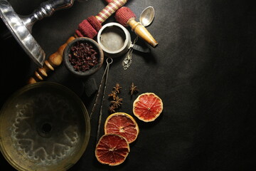 bowl with tobacco for hookah. narghile smoking. berries and fruits on a dark background.