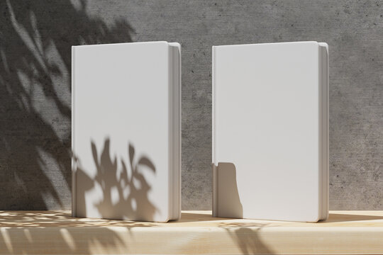 Mockup of two books that stand on a wooden shelf with a gray concrete wall. Mockup for your cover design, notebook. Blank cover for your design. 3d render.