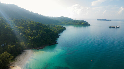 Aerial drone view of blue seaside by an island at Tinggi Island or Pulau Tinggi in Mersing, Johor,...