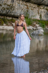 A Lovely Blonde Bikini Model Enjoys The Summer Weather On A Lake