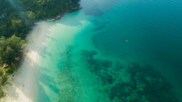 Aerial drone view of coast scenery with blue sea water at Tinggi Island or Pulau Tinggi in Mersing, Johor, Malaysia