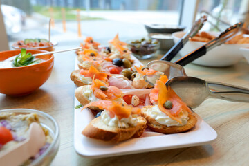 Bruschetta with cream cheese and smoked salmon on a table at breakfast.Selective focus.