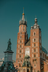 Fototapeta na wymiar View of Saint Mary Basilica in Krakow, Poland on a summer sunny day viewed from the arcades at main city square.