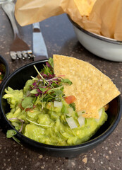 closeup of chips and guacamole on the table