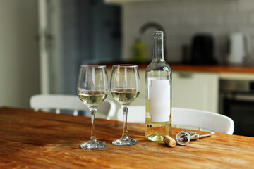 Two cold glasses of sparkling wine. One wine bottels on background.