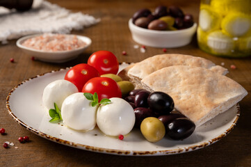 Labneh - yogurt balls with tomatoes, olives, pita and oregano