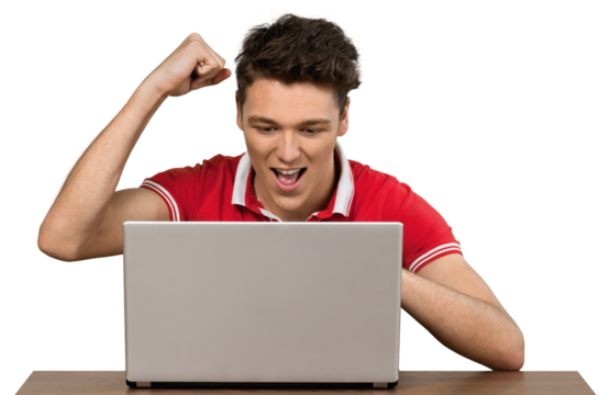 Young man cheering at his computer