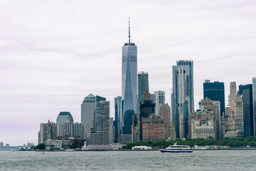 Lower Manhattan from the Hudson River on a Partly Cloudy Day - obrazy, fototapety, plakaty