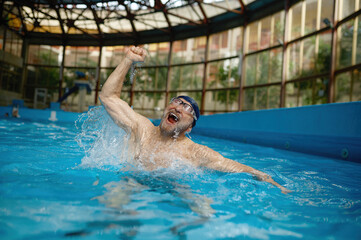 Excited senior man joy rejoicing in victory in swimming competitions