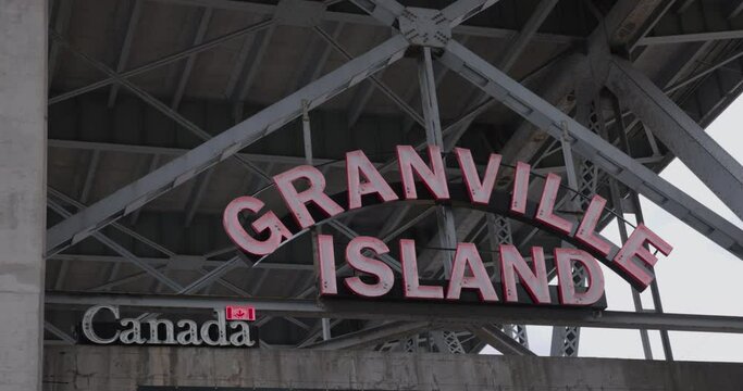 Vancouver, B.C Canada - April 13th 2023 - Granville island sign under bridge