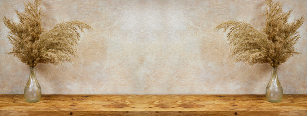 Vase of golden reeds on wood board  with copy space