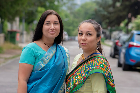 A street portrait of two women in saris.