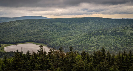 Aerial View of a Mountain Lake With Evergreens Pine Trees on a Cloudy Stormy Day