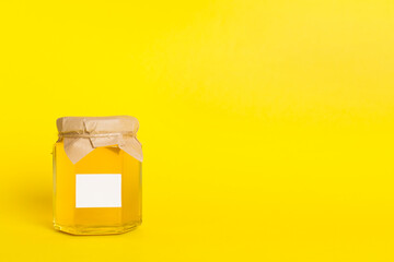 Jar with honey on color background. Mock up design