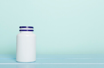 Plastic bottle for vitamins on wooden table