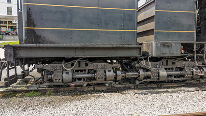 Close Up View of a Antique Shay Steam Locomotive's Running Gears as it's Warming Up For Days Work