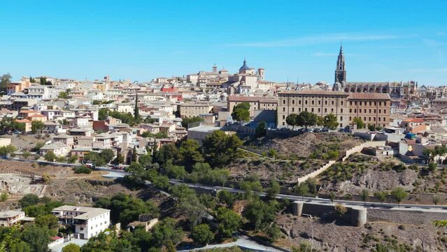 Panorama of the ancient city of Toledo on the banks of the Tagus River on a sunny day against the blue sky. Capital of the province of Toledo and  autonomous community of Castilla&ndash;La Mancha, Spain. 4K